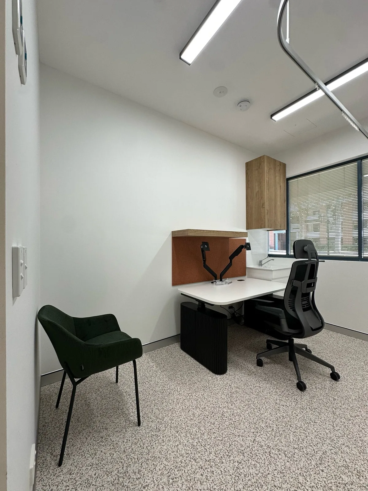 Consulting room fit-out with desk, task chair and guest chair