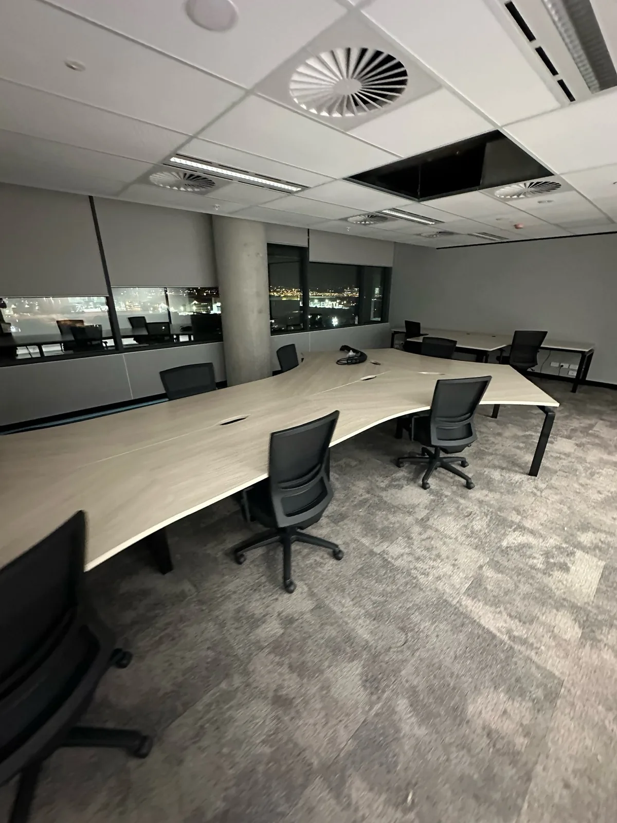 Curved desks and task chairs across an open-plan office
