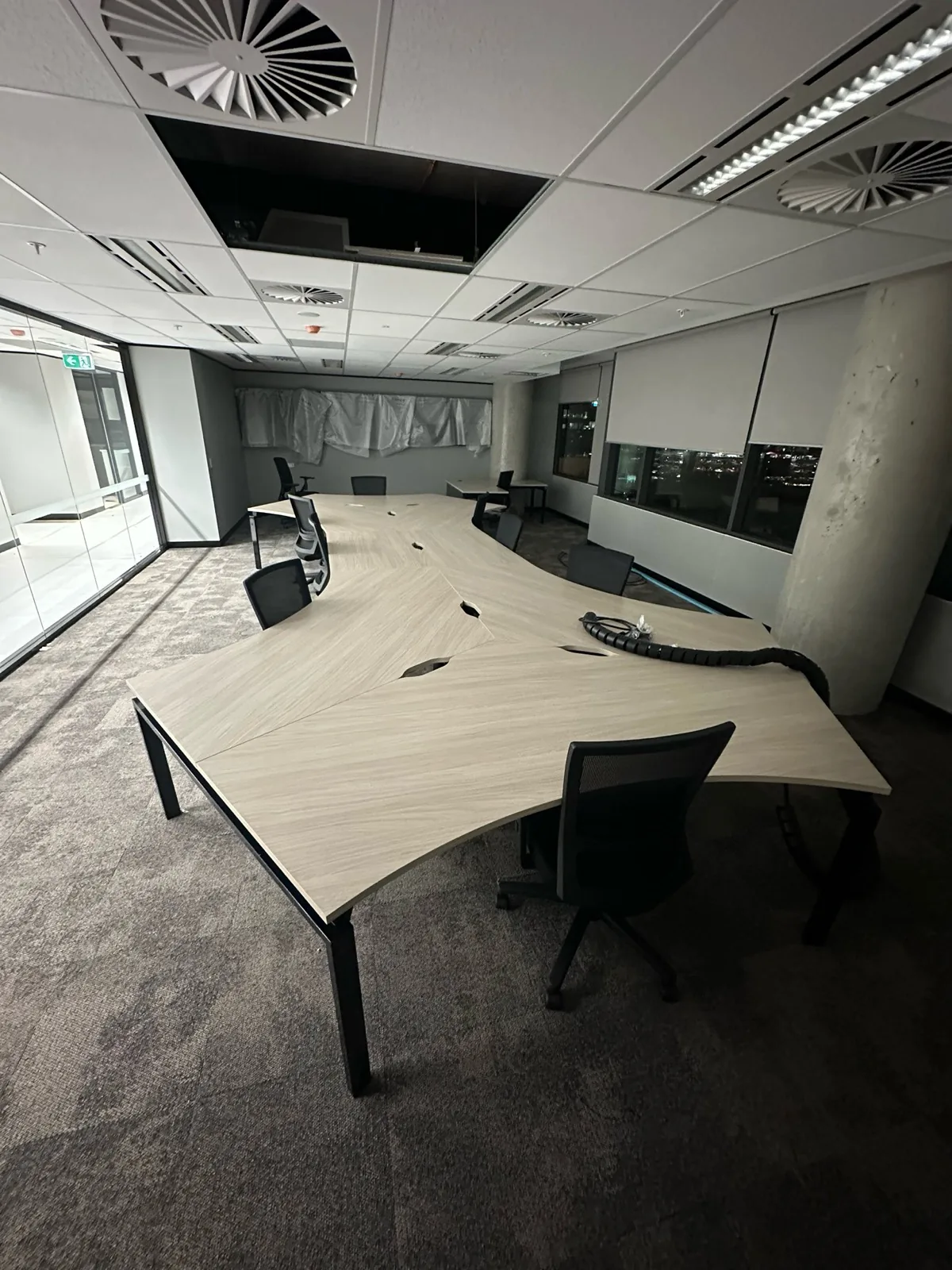 Curved workstation pods installed in an open-plan office