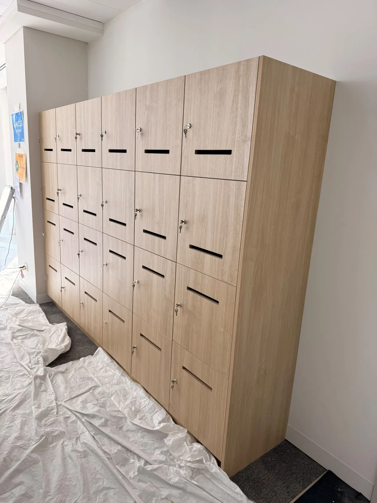 Freestanding bank of timber-look lockers installed in an office