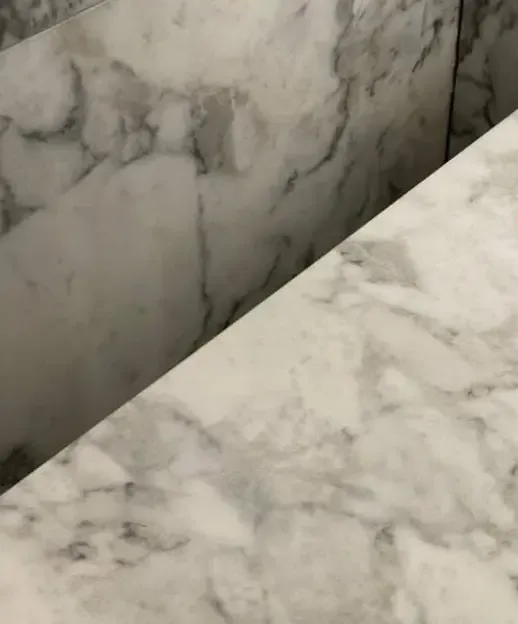 After: tap hole filled flush and the marble veining restored