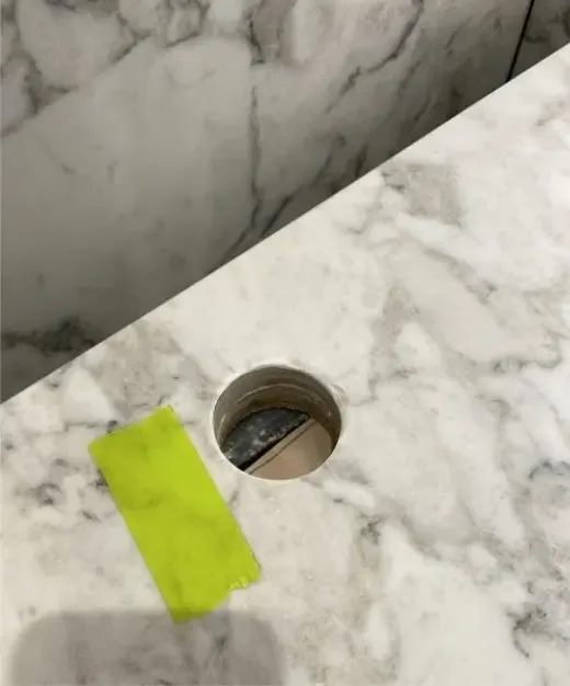 Before: redundant tap hole in a marble benchtop