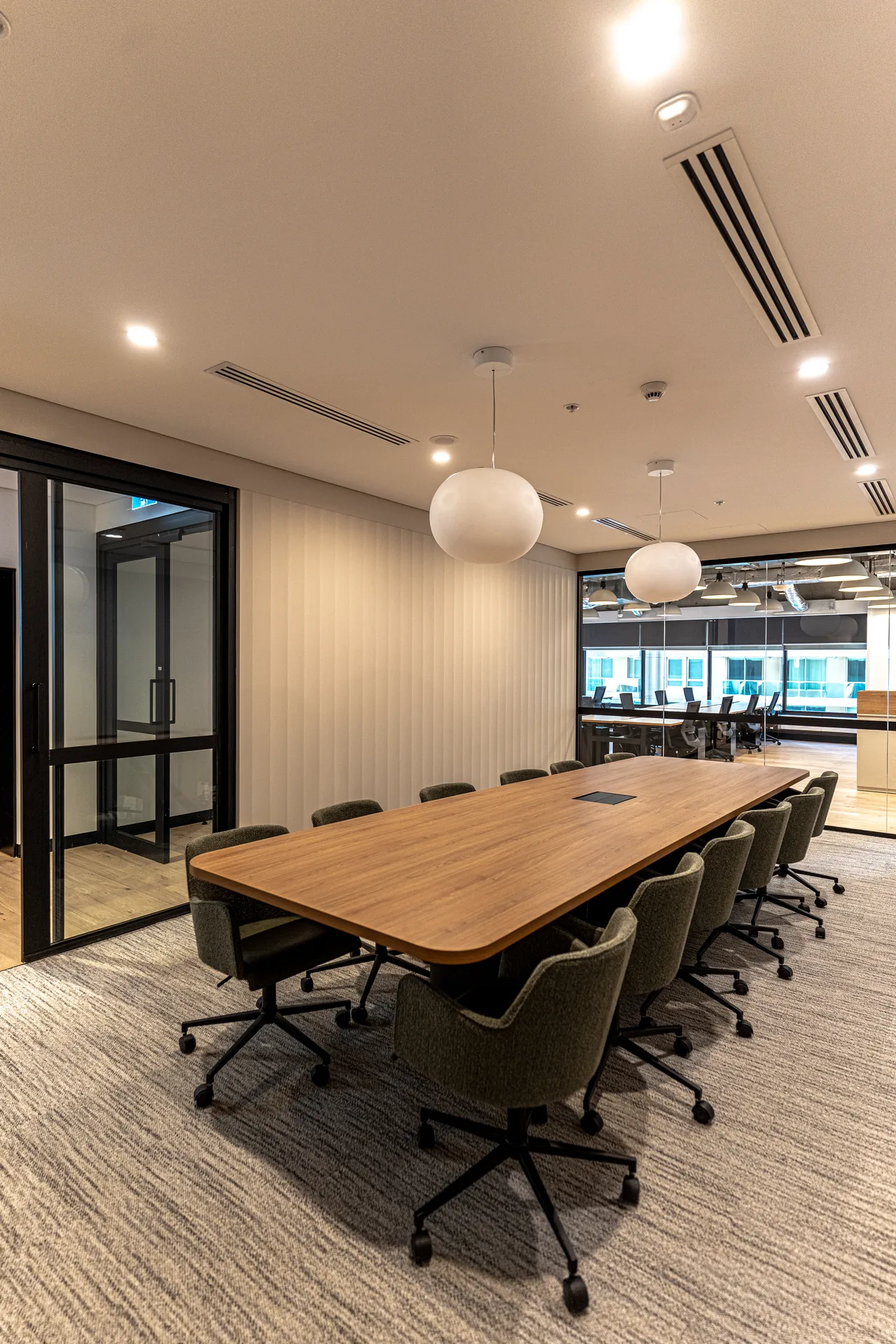 Meeting room with timber table and wall screen in a Sydney office