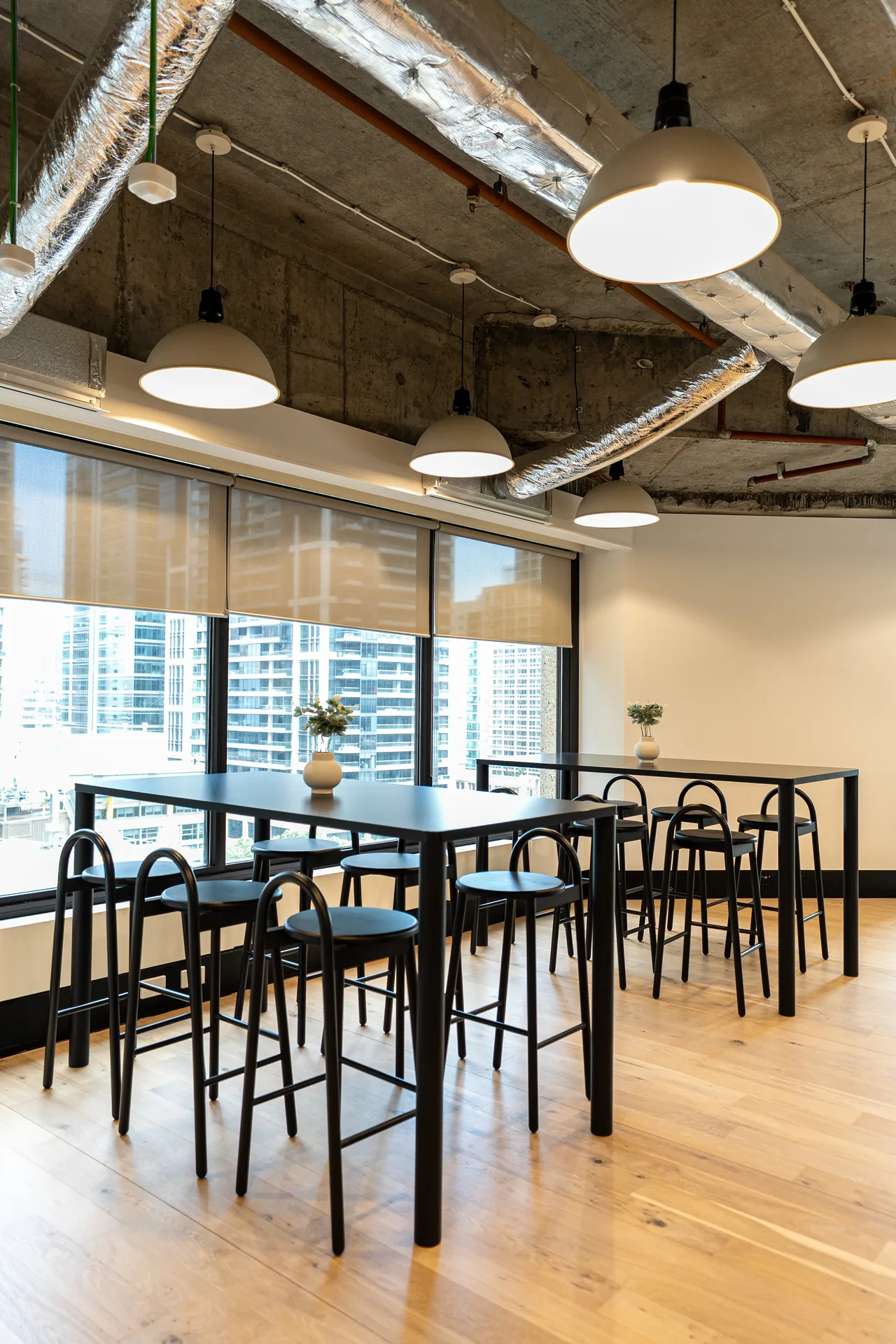 High bar table and leaners by the window in an office breakout area