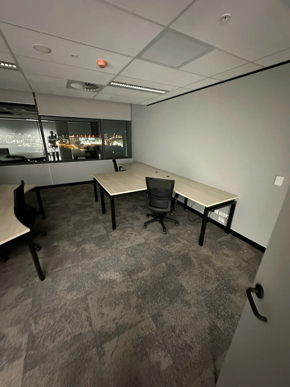 L-shaped office desks installed in a project room