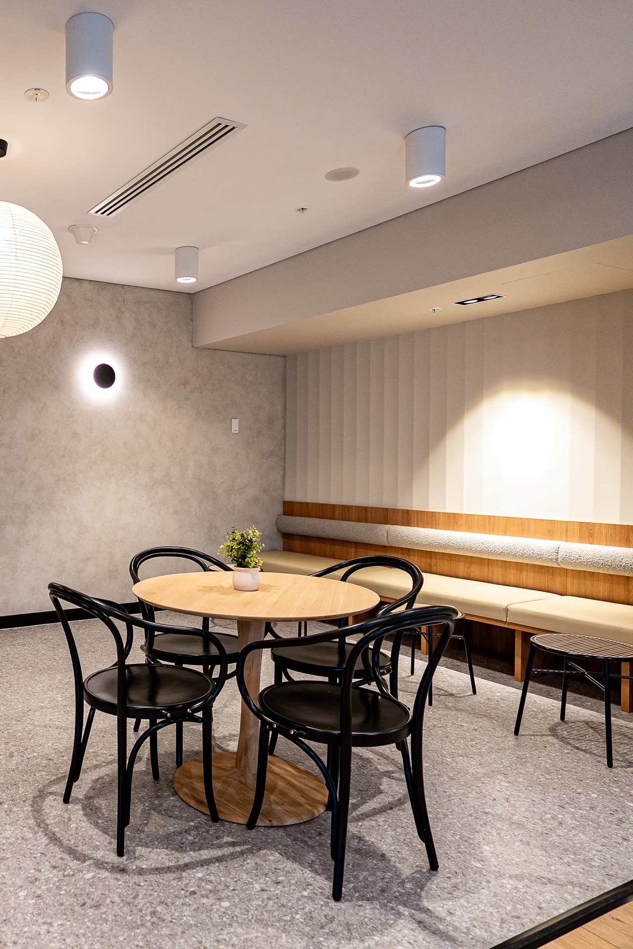 Banquette nook and round table in a fitted office kitchenette