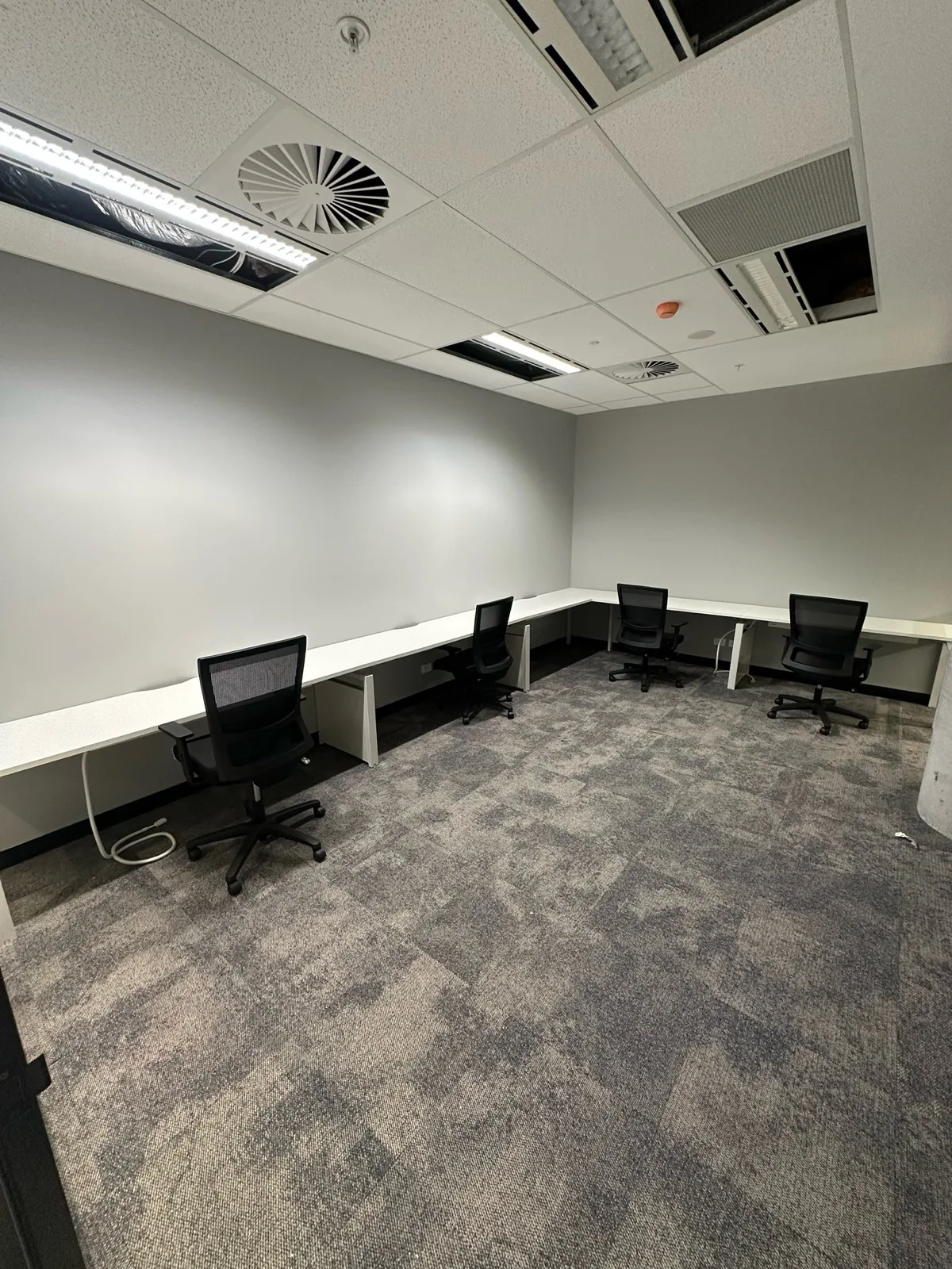 Perimeter desks installed around an office room