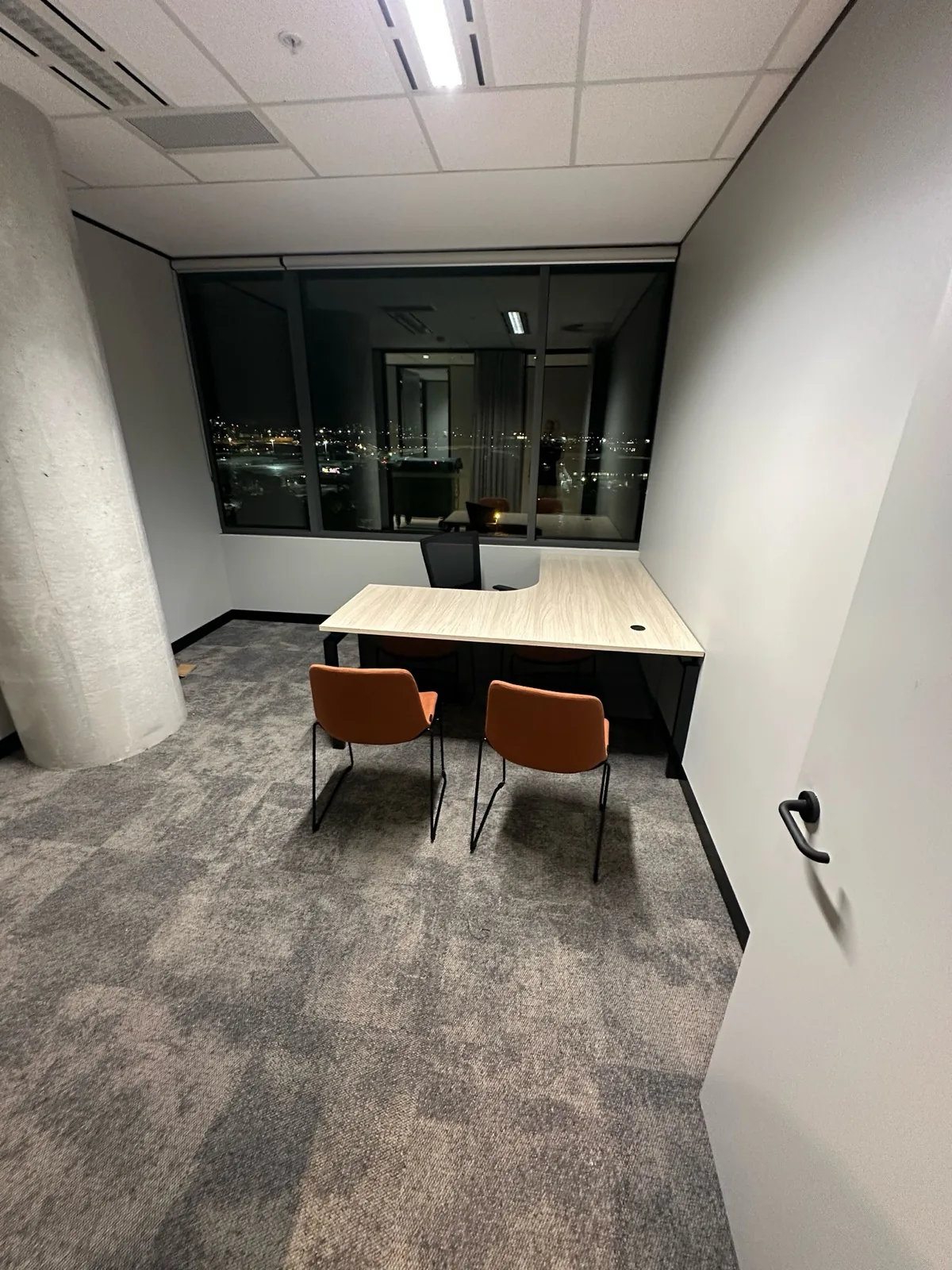 Private office with desk and two guest chairs