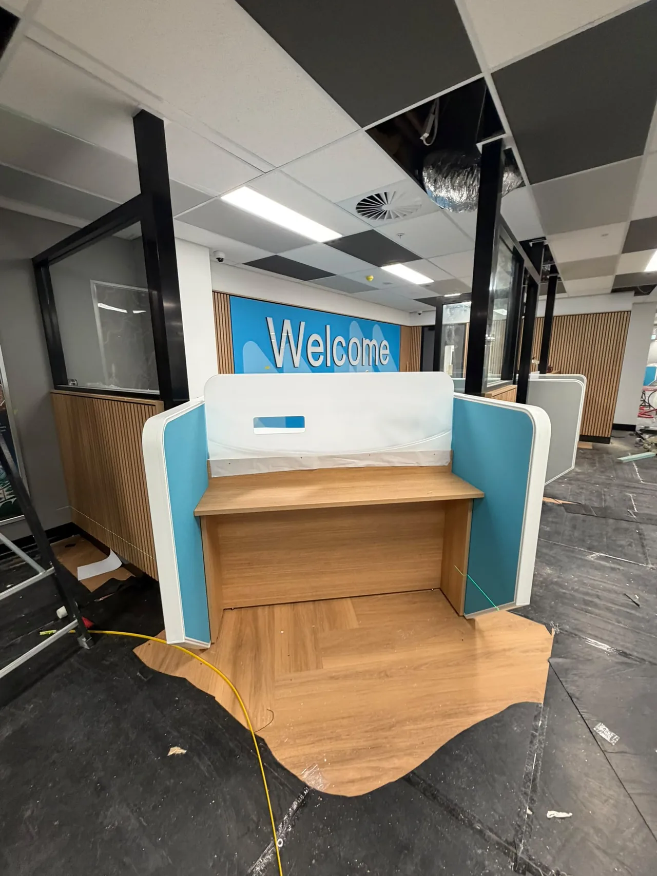 Service counter installed in front of a welcome wall