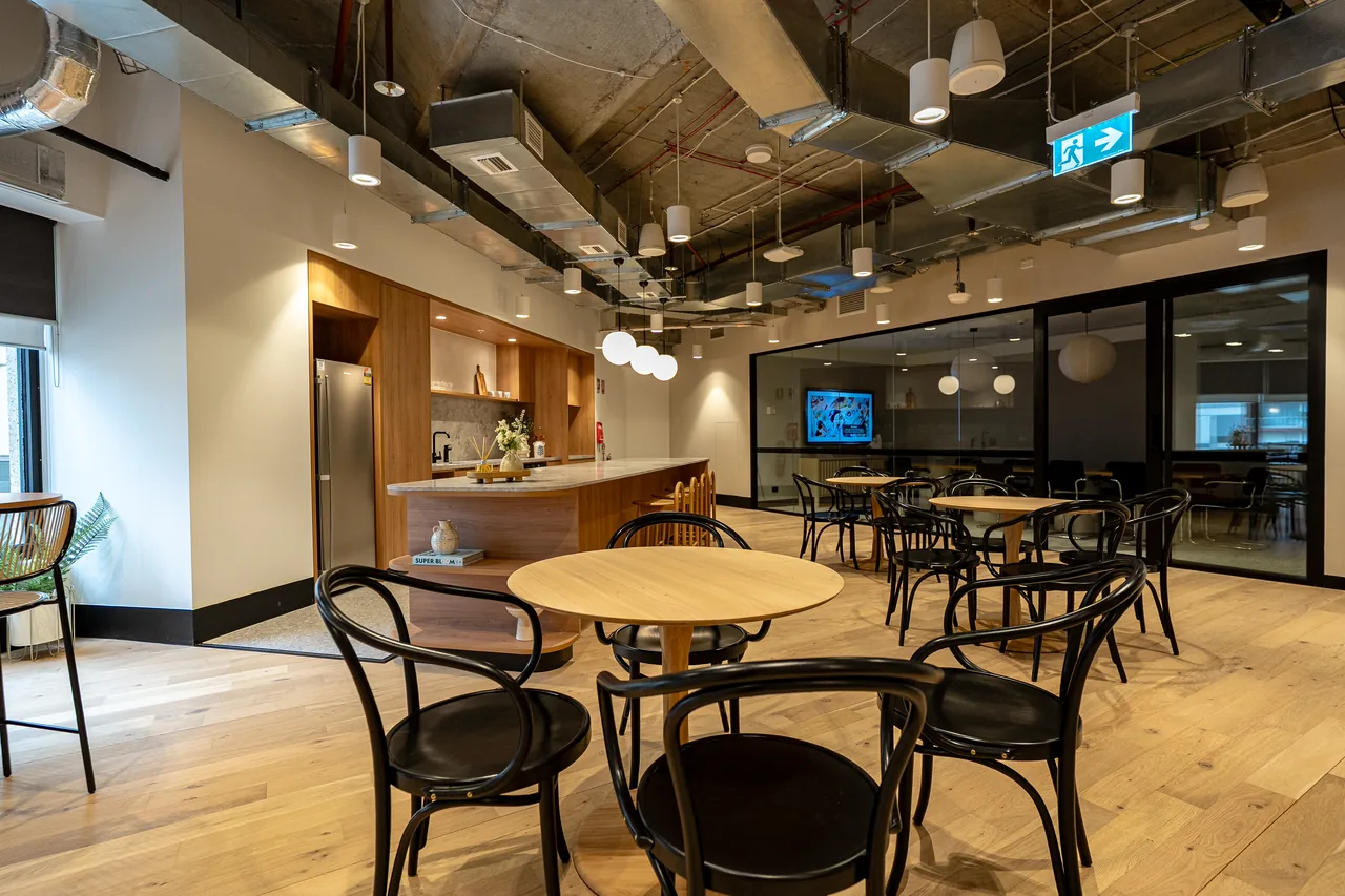 Timber kitchen joinery and island bench in a fitted-out commercial office