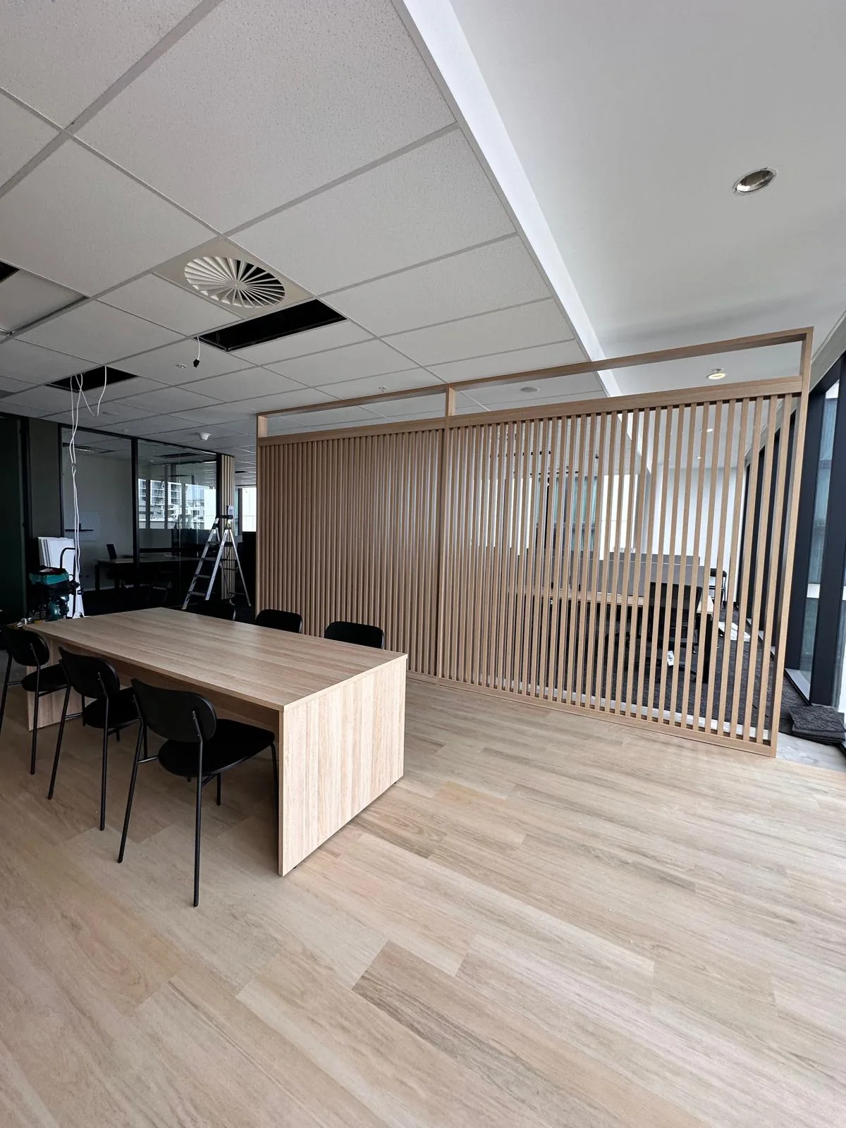 Meeting area with a timber slat screen wall and table