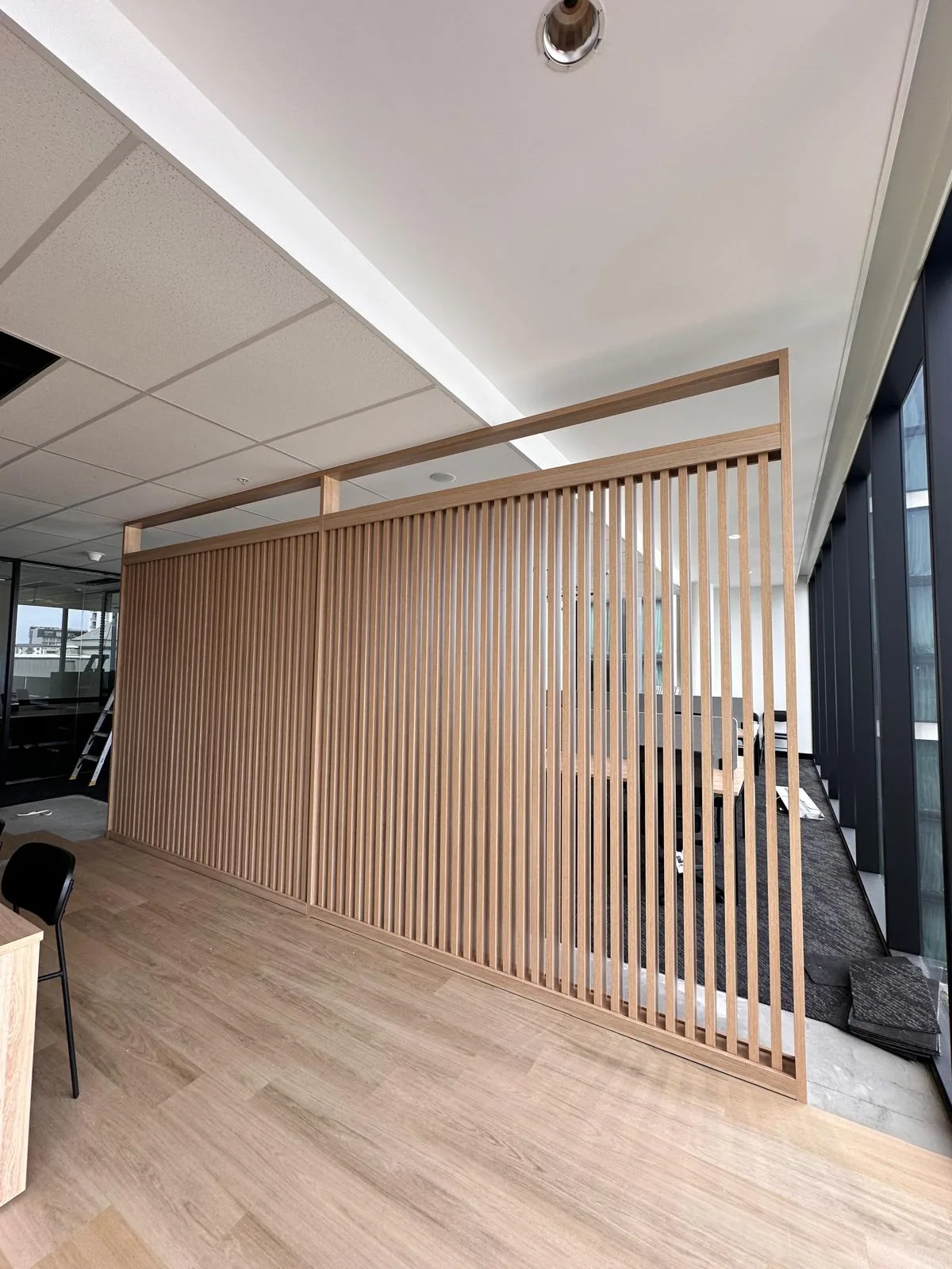 Timber slat screen partition installed in an office
