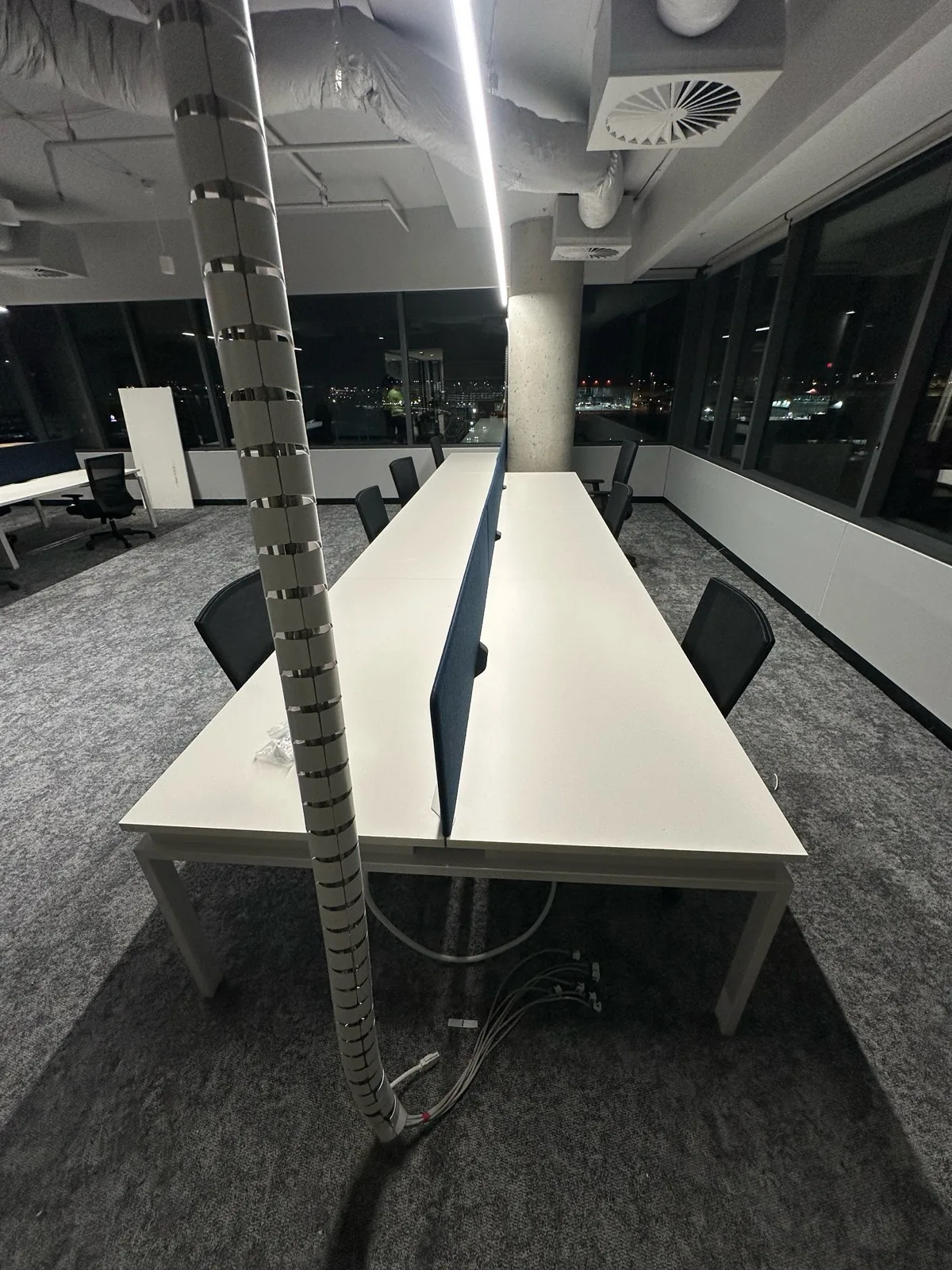 Workstation bench with cable riser installed in an office