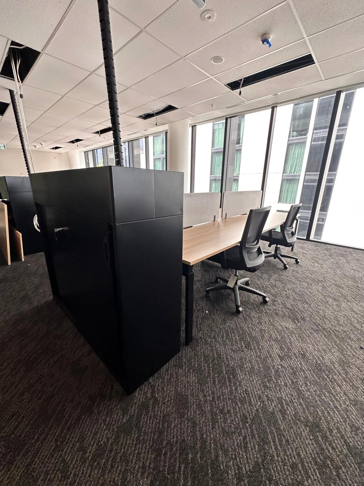 Workstations with a storage tower in an open-plan office